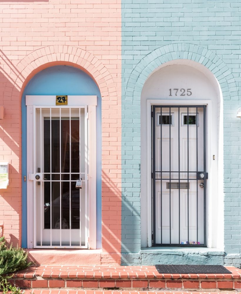 two white wooden doors with grills